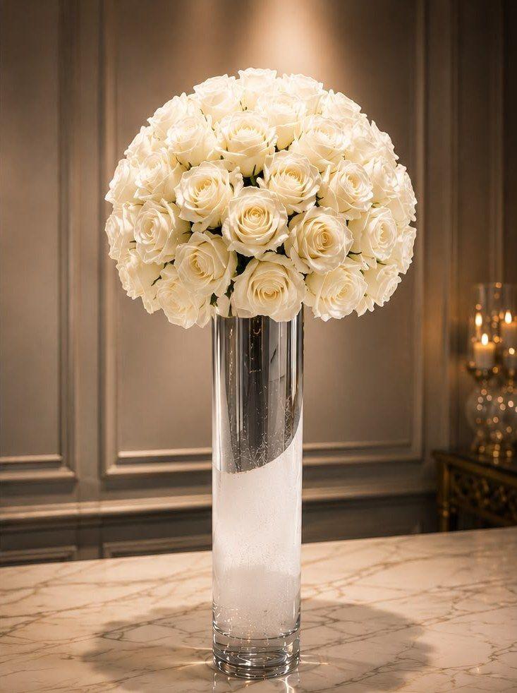 Corporate arrangement of white roses on a crystal column