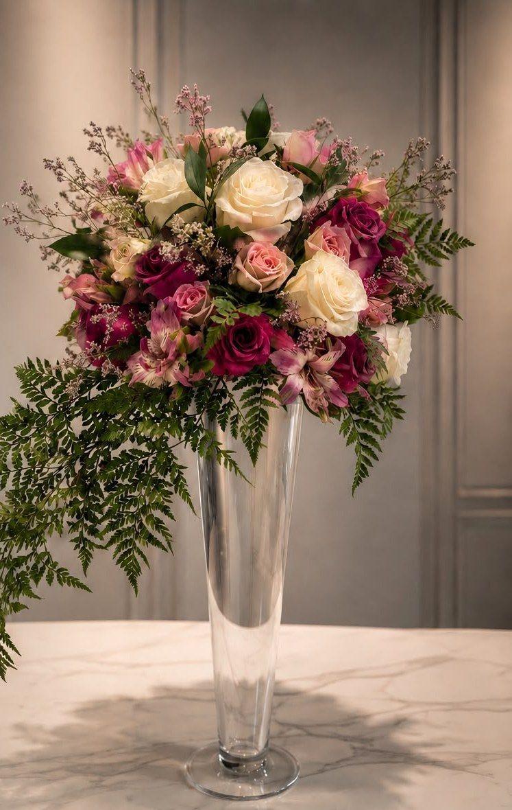 Tall centerpiece with burgundy and cream roses
